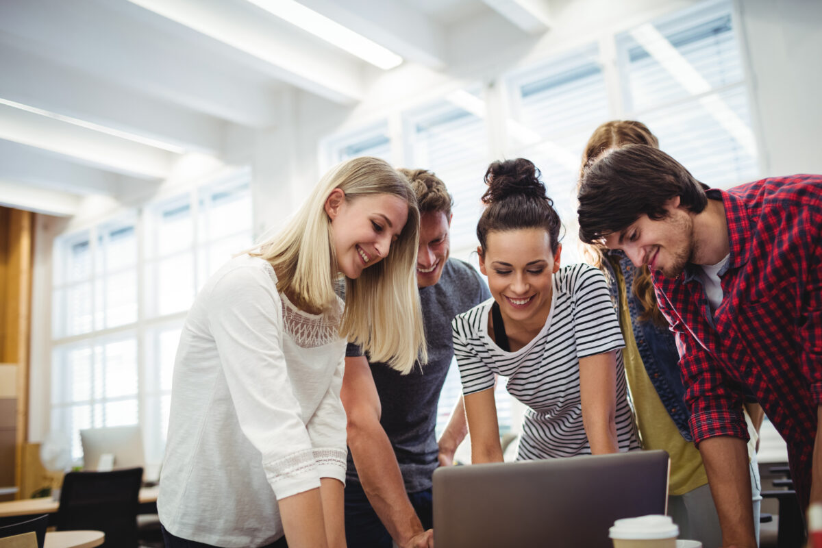 Group of business executives using laptop at their desk in the office